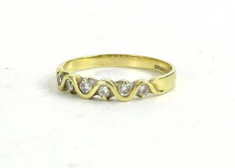 An 18ct gold diamond half hoop eternity ring, with wave design gold centre set with six tiny diamonds, 2.2g all in.