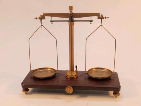 A Griffin & Tatlock Ltd gilt metal balances with circular pans and on bakelite