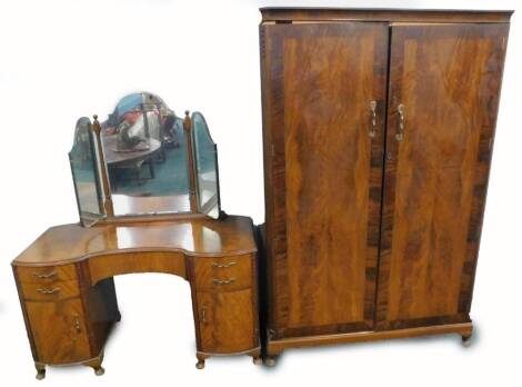 A mahogany wardrobe, with two cross banded doors on cabriole legs, and a matching concave fronted dressing table. (2)