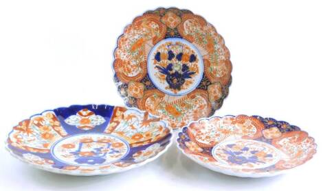 A pair of Japanese Imari plates, 25cm diameter, and another similar.