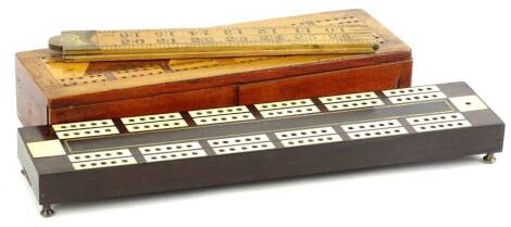 A 19thC rosewood and ivory inlaid cribbage scorer, with sliding compartment to underside, an Edwardian mahogany example with inlaid lid, sliding compartments to side, written to underside Mother September 21 1900, and a wooden folding Rabone ruler.