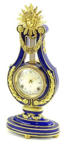 A Victoria and Albert Museum replica French mantel clock, the lyre shaped case with blue enamel decoration and gilt metal mounts, the paper dial with paste set bezel, 38cm H.