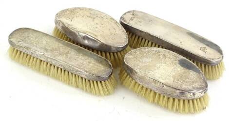 Four Edwardian silver mounted hand brushes, London 1908.