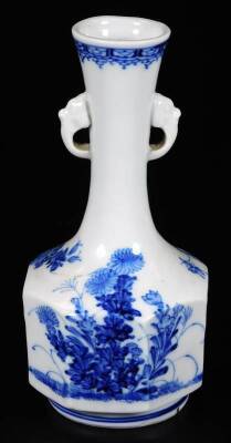 A Japanese Hirado porcelain bottle vase, of octagonal form with stylised mask handles and decorated with peonies and flora in underglaze blue, 19cm H.