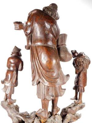 A 19thC Chinese carving, centred by a bearded figure in flowing robes, flanked by two smaller figures on an entwined base, in four sections, soft wood, 68cm H. - 7