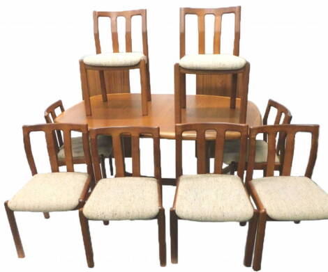 A Danish Dyrlund teak dining room suite, comprising extending dining table, with two loose leaves on end supports and a set of six chairs, the table 96cm x 259cm extended. The upholstery in this lot does not comply with the 1988 (Fire & Fire Furnishing) R