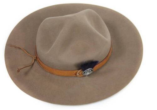 A 20thC Canadian Mountie hat, by Christy's of London, with a brown leather banding and fleur-de-lis Quebec emblem, 36cm W, interior dimensions approx. 21cm x 16cm, with chin strap. (boxed)