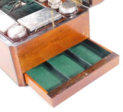 A Victorian walnut cased travel box, the shaped rectangular body centred by a mother of pearl cartouche, with ebonised outline and fitted interior, containing a number of various jars, bottles, etc., some with plated lids, with a green velvet lining and s - 4