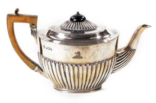 A Victorian silver teapot, of compressed oval form, part reeded with angular thumb mould handle, bearing Langham family crest of a muzzled bear armorial, London 1892, 15cm H, 14oz all in.