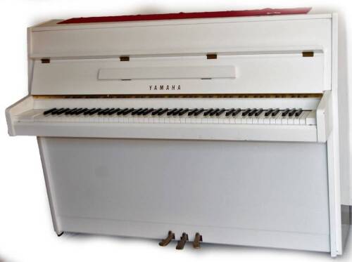A late 20thC Yamaha white upright piano, iron framed, 109cm H, 151cm W, 63cm D.