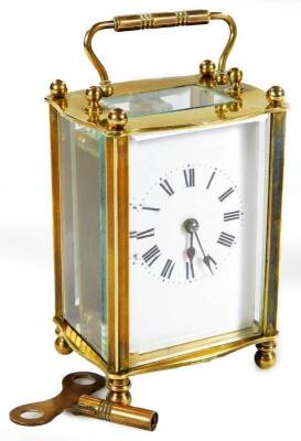 An early 20thC brass carriage clock, the 5.5cm back plate with Roman numeric dial, in a five part glazed case, revealing a single train movement, marked Made In France, and numbered 2685, on orb feet, with revealed keywind movement, 12cm H.