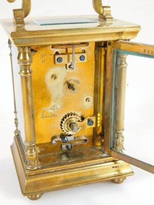 A late 19thC brass carriage clock, with ivory coloured 6cm W dial with Arabic numerals, stencilled with gilt flowers and revealing a twin train keywind movement, in a five part glazed case, on compressed orb feet, flanked by quarter columns, surmounted by - 4