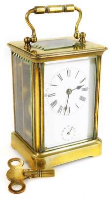 A late 19thC brass alarm carriage clock, the 5.5cm dial with Roman numerals and subsidiary Arabic second hand, revealing a twin train movement with bell, partially jewelled, in a five part glazed case, on shaped feet, 12cm H.