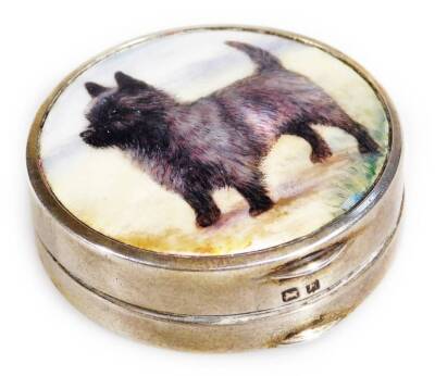 A George V silver and enamel powder compact, by Hamilton & Inches, the 4cm Dia. lid set with a Cairn terrier, with thumb mould handle, Birmingham 1929.