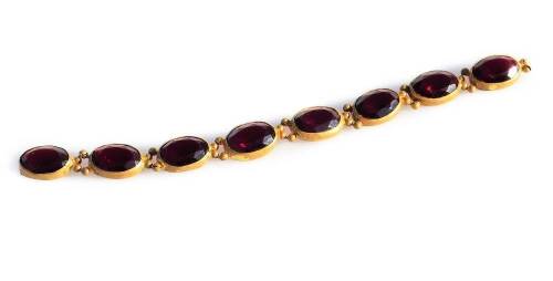 A Georgian garnet set bracelet, with eight oval stones, in gilt metal settings, possibly some missing (AF), the current bracelet 16.5cm L.