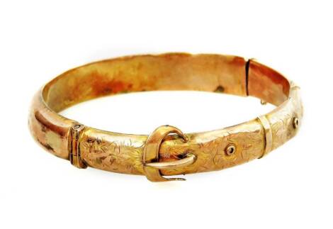 A hinged bangle, with buckle and floral design, safety chain (AF, dented and bent), Apollo design, 13.6g all in.