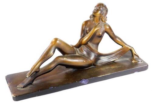 A 1930's Art Deco Bacci & Bacci plaster figure, of a reclining lady semi-clad, on an rectangular base, 27cm H.