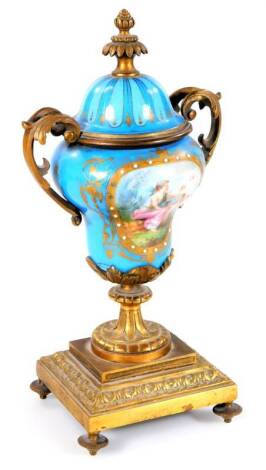 A 19thC continental porcelain garniture vase, of inverted baluster form, with gilt metal mounts, Sevres porcelain plaques, a floral finial, pierced handles and acanthus leaf stem, on a rectangular base terminating in compressed orb feet, 29cm H.