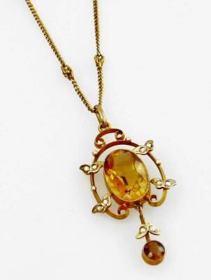 An Art Nouveau pendant and chain, the drop pendant set with two citrines, and seed pearls, in 9ct gold frame, on a 9ct gold fine link chain, the pendant 4.5cm H.