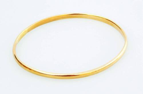 A bangle, of plain design, oval shaped, yellow metal, partially marked 750, 17.9g all in.