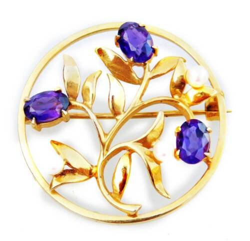 A 9ct gold circular brooch, set with floral design, with purple amethyst flower heads, and seed pearl heads, 6.3g all in, 3cm W.