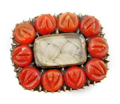 A Victorian memorial brooch, with coral beaded borders, and a memorial panel to centre with plaited hair, 2cm W, on yellow metal backing, unmarked.