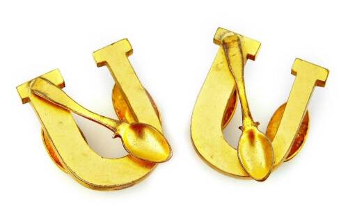 A pair of U shaped clips, with spoon motif.