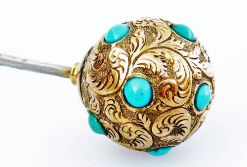 A Victorian stick pin, with bull design top, set with small turquoise stones and scroll design feathers, yellow metal, unmarked, the pin 8.5cm H, the ball 1.5cm H, 3.4g.