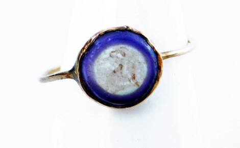 A Victorian dress ring, with purple plaster design mount, possibly lacking stone, in yellow metal unmarked, 0.6g.