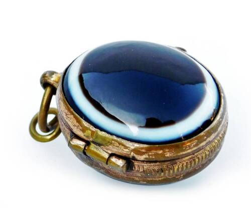 A bull's eye agate Victorian pendant, the pendant with opening as a locket, with gilt metal surrounds and frame, 2cm H, 4.3g all in.