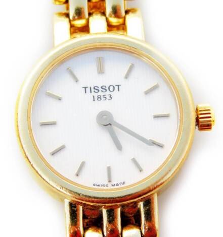 A Tissot ladies wristwatch, with three bar design bracelet, the circular watch head with white enamel backing, marked Tissot 1853, with Swiss movement, marks to back and wristwatch 750, 33.5g all in.