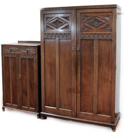 A 20thC oak Tudor Rose bedroom pair, comprising of a double door wardrobe, 188cm x 126cm x 49cm, and compactum chest, each partially carved on orb feet. (2)