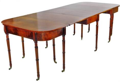 A George III mahogany D-end and dropleaf dining table, with turned legs and castors, 104cm W, 256cm L. N.B There are no brass clips with this table.