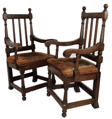 A pair of Edwardian oak elbow chairs, with vertical splats, scroll arms, turned legs and block feet, 115cm H.