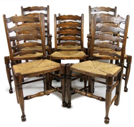 A set of six 20thC ash and elm stained ladder back dining chairs, with shaped splats, rush seats, and turned forelegs joined by a turned stretcher, to include two carvers, 107cm H.