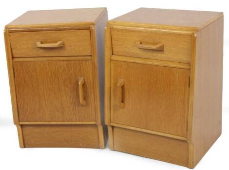 A pair of vintage 1960's E Gomme G-Plan light oak pedestal cabinets, each with a drawer above cupboard and shaped handles, 52cm H, 37cm W, 28cm D.