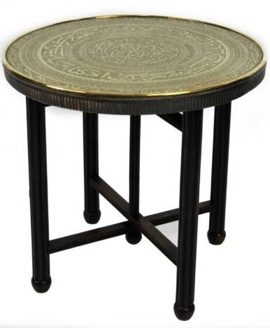 A Benares brass tray topped table, the circular top heavily decorated with a repeat geometric pattern, on X framed support, 60cm H, 63cm Dia.