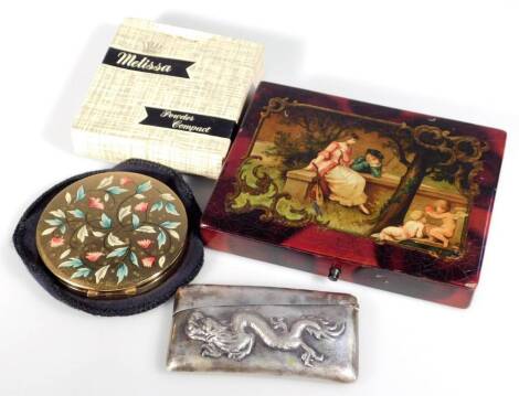 An early 20thC papier mache box, set with a classical scene of figures aside cherubs, in a naturalistic setting, with red and black surround and part fitted interior, 14cm W, a cased Melissa powder compact and a Chinese Macho card case raised with a drag