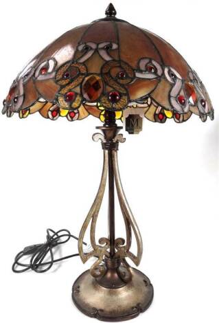 An as new table lamp, with Tiffany style shade, predominately in brown, orange and red, 68cm H.