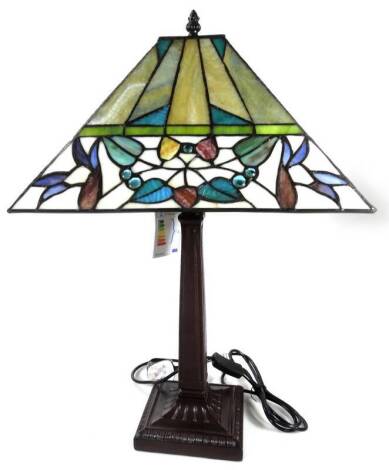 An as new table lamp, with Tiffany style shade, with a repeat floral pattern predominately in cream, green and yellow, 63cm H.