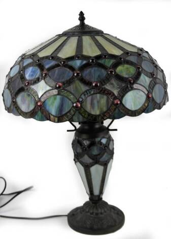 An as new table lamp, with Tiffany style shade, predominately in blue, red and green, 61cm H.