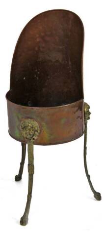 A early 20thC copper and brass coal scuttle, on fixed stand with mask head and lion's paw feet, 71cm H.