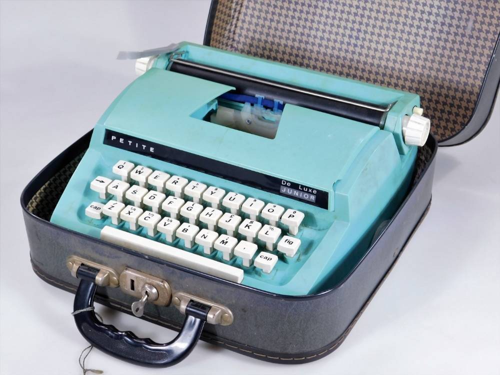 A vintage 1960's Petite Deluxe Junior portable typewriter, in