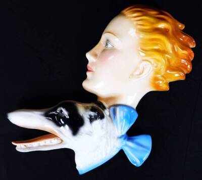 A 1930's Goebel Art Deco wall plaque, lady with borzoi, polychrome decorated, 27cm H.