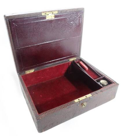 A late 19thC pressed leather travel box, the part velvet lined interior with document pouch and fitted with ink bottle, the lock stamped Bramah Piccadily, with flush gilt metal handle, 12cm H, 31cm W, 24cm D.