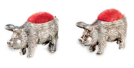 A pair of 20thC silver plated pig pin cushions, with red velvet tops, 4cm W, marks rubbed. (2)