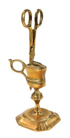 A brass wick cutter on stand, in two sections, with candlestick base and compressed circular handle, 20cm H.