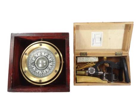 A late 20thC ship's compass, with 10cm Dia. dial and metal case and wooden box, 12cm H, 20cm W, 20cm D and a microscope. (2)