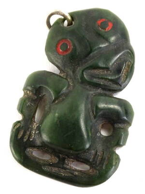 A New Zealand Maori nephrite Hei-tiki , with a tilted head, a forked tongue and red eyes, pierce hole for suspension, etc. 6cm H, 4.5cm W.