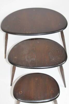 A 20thC Ercol dark wood vintage nest of three tables, with pebble or kidney shaped tops on turned legs, the largest 42cm H, 67cm W, 43cm D. - 2